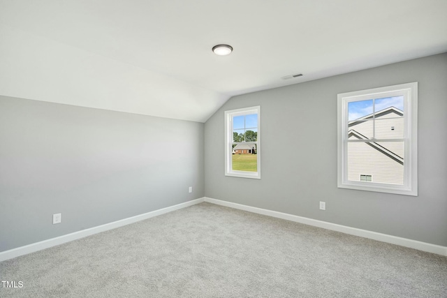 bonus room featuring lofted ceiling, carpet, baseboards, and visible vents