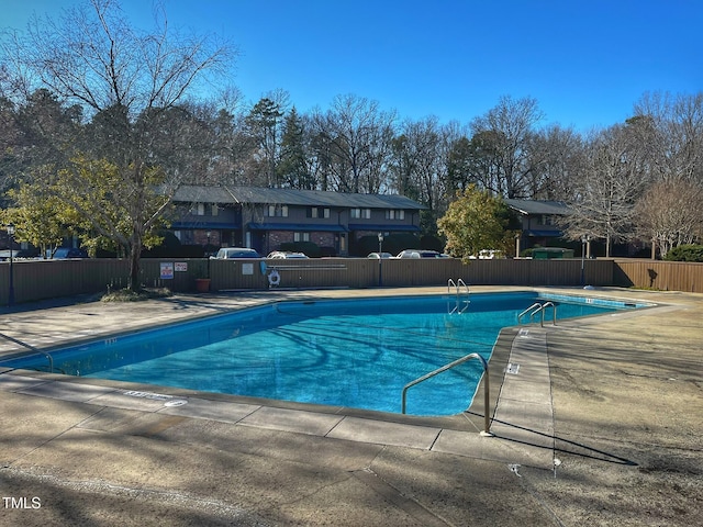 community pool featuring a patio and fence