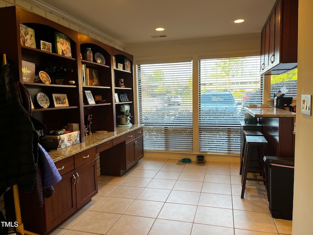 office area featuring visible vents, built in desk, recessed lighting, crown molding, and light tile patterned floors