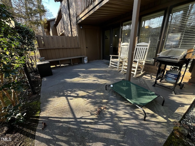 view of patio / terrace with a grill and fence