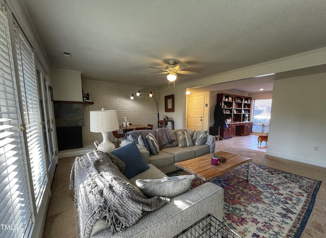 carpeted living room featuring a ceiling fan, baseboards, visible vents, brick wall, and a textured ceiling