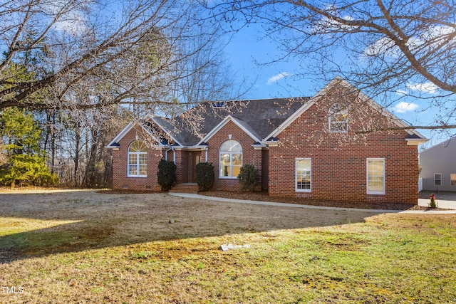 view of front of home featuring a front yard, crawl space, and brick siding