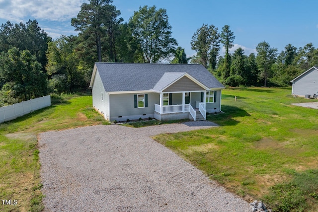 view of front of house featuring covered porch, fence, crawl space, a front lawn, and gravel driveway