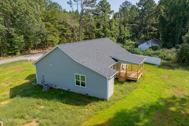 exterior space featuring a shingled roof, central AC unit, a lawn, crawl space, and a deck