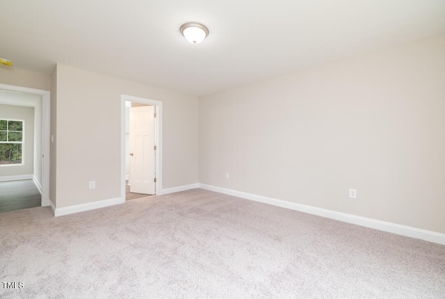 unfurnished bedroom with carpet flooring and baseboards