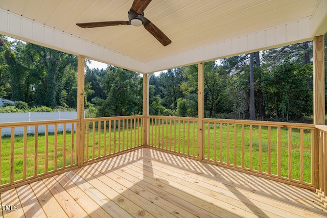 deck featuring a yard and a ceiling fan