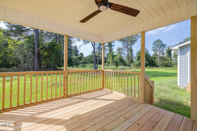 deck with ceiling fan and a yard