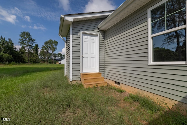 doorway to property with a yard and crawl space