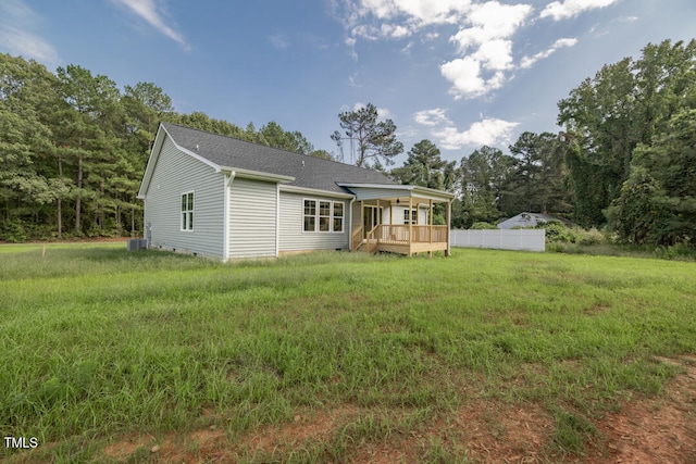 back of house featuring a shingled roof, crawl space, fence, a deck, and a yard