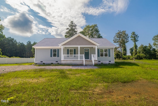 view of front of house featuring covered porch, roof with shingles, crawl space, and a front yard