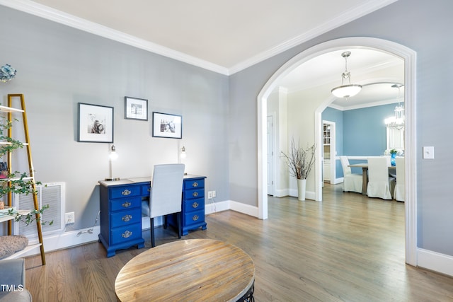 office space featuring arched walkways, wood finished floors, visible vents, baseboards, and crown molding