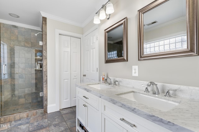 bathroom with a shower stall, a sink, visible vents, and crown molding