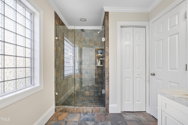 bathroom featuring baseboards, stone finish flooring, a stall shower, and crown molding