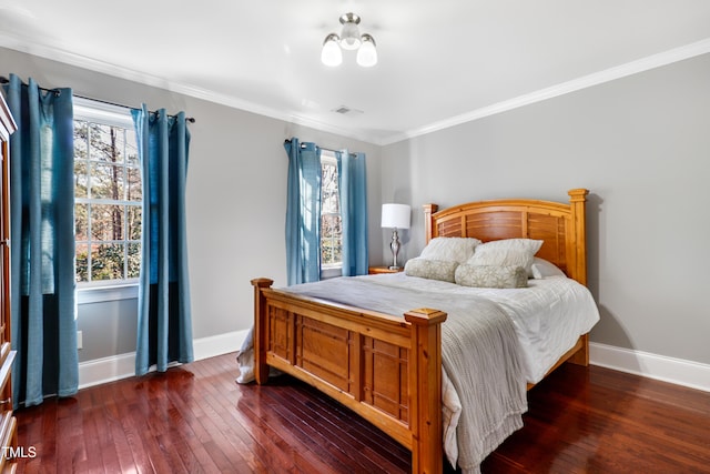 bedroom featuring dark wood-style floors, crown molding, and baseboards