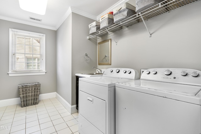 laundry area featuring washer and clothes dryer, light tile patterned floors, visible vents, ornamental molding, and laundry area