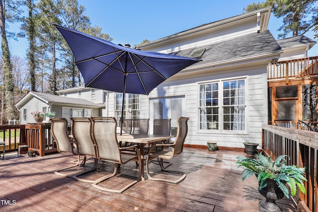 wooden terrace with outdoor dining area