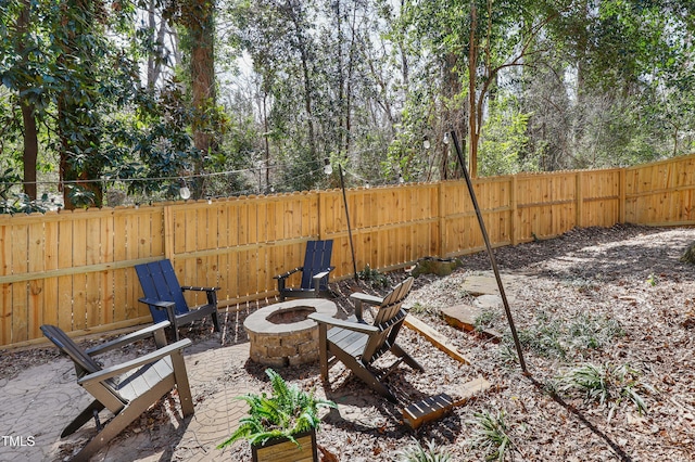 view of patio / terrace featuring an outdoor fire pit and a fenced backyard