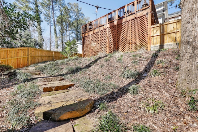 view of yard featuring a deck and fence