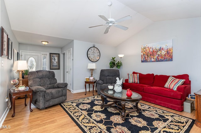 living room featuring vaulted ceiling, ceiling fan, wood finished floors, and baseboards