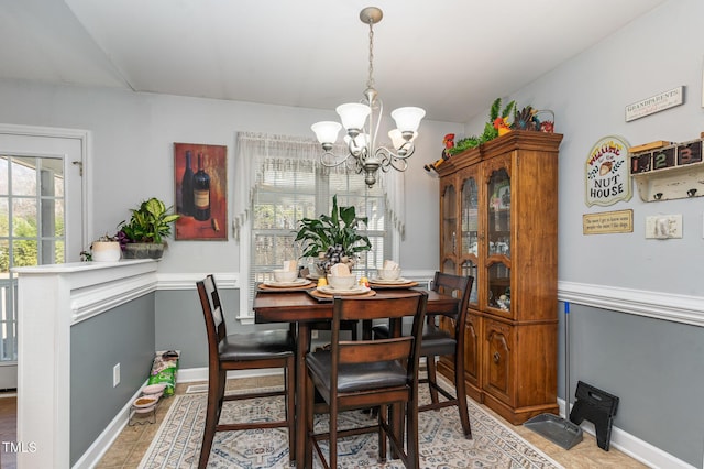 dining room with baseboards and a notable chandelier