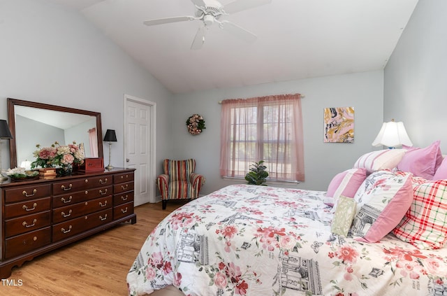 bedroom with lofted ceiling, light wood finished floors, and a ceiling fan