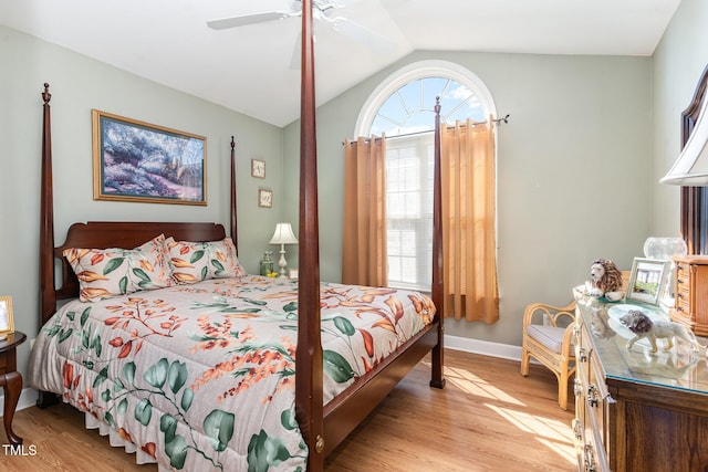 bedroom with lofted ceiling, ceiling fan, baseboards, and wood finished floors