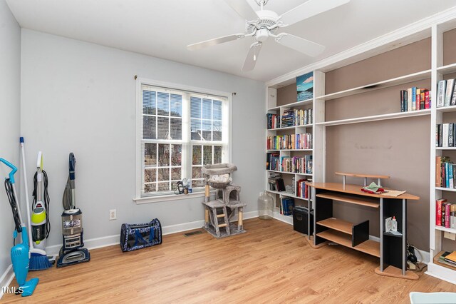 miscellaneous room with a ceiling fan, baseboards, and wood finished floors