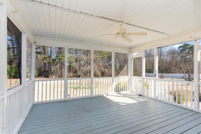 unfurnished sunroom featuring a ceiling fan