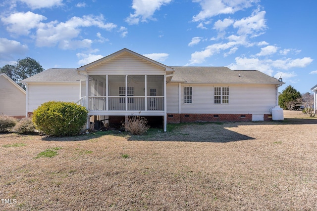 rear view of property with a sunroom, crawl space, and a lawn