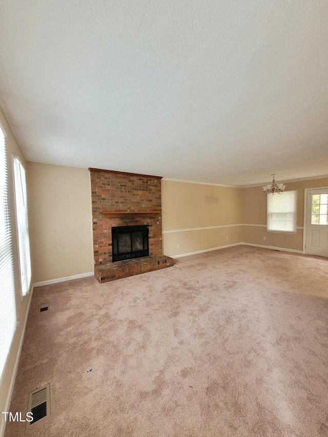 unfurnished living room with carpet, a fireplace, and visible vents