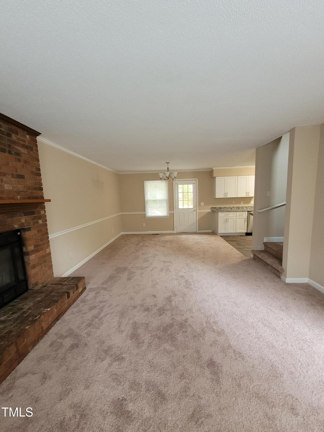 unfurnished living room with light carpet, a brick fireplace, a chandelier, and baseboards