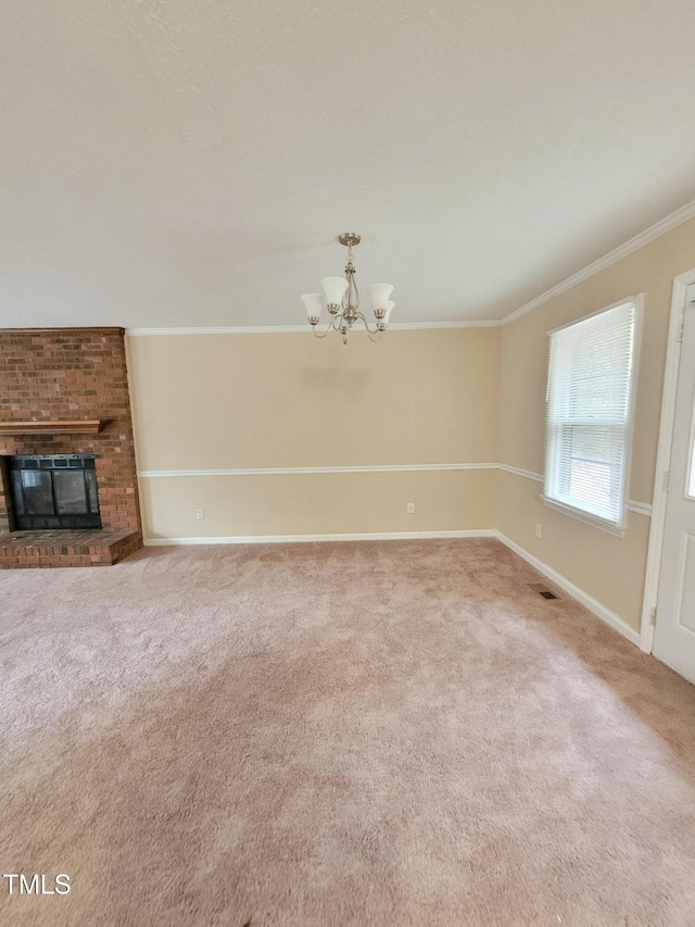 unfurnished living room with a chandelier, a fireplace, baseboards, carpet, and crown molding