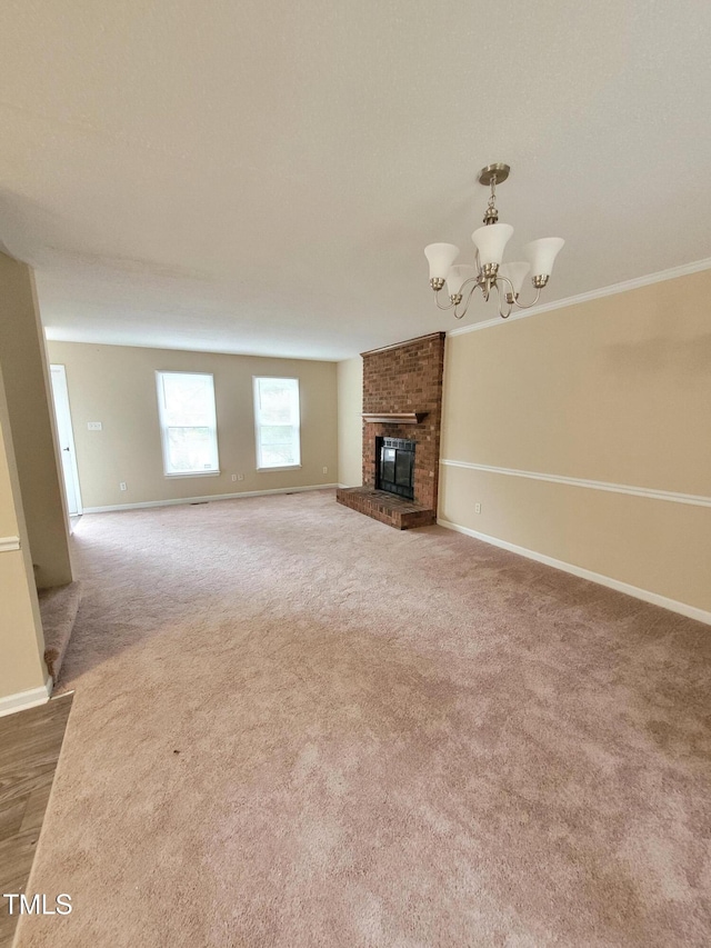 unfurnished living room with a notable chandelier, a fireplace, baseboards, and carpet flooring