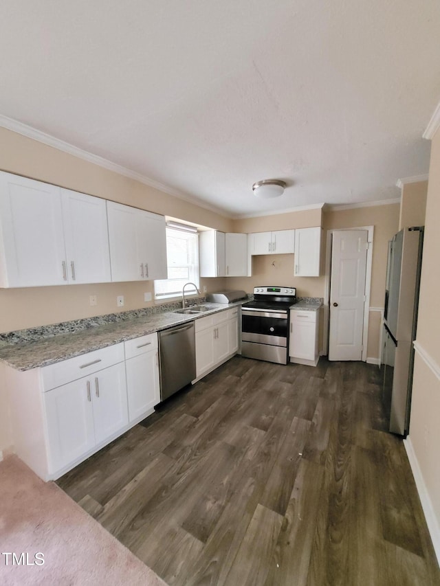 kitchen featuring ornamental molding, stainless steel appliances, dark wood-type flooring, and white cabinetry