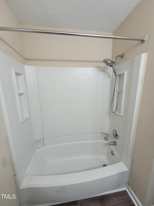 full bathroom with bathtub / shower combination and wood finished floors