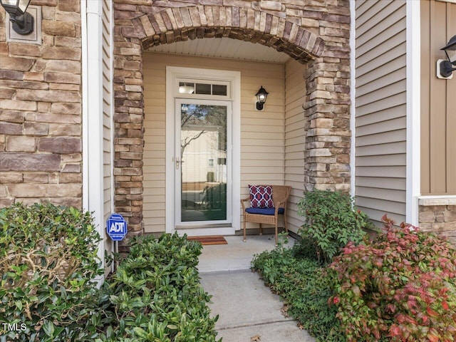 property entrance with stone siding