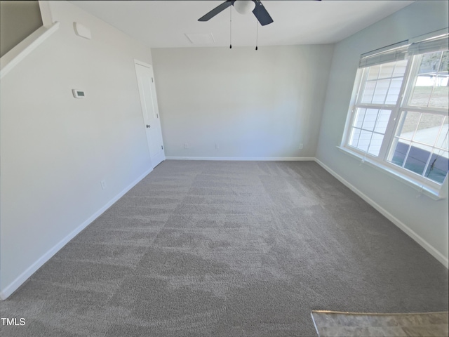 carpeted spare room with ceiling fan and baseboards