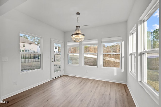 unfurnished sunroom featuring a chandelier and visible vents