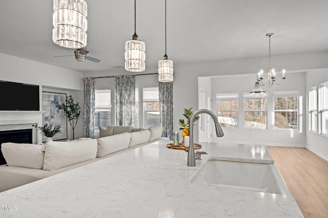 kitchen with a wealth of natural light, open floor plan, and a sink