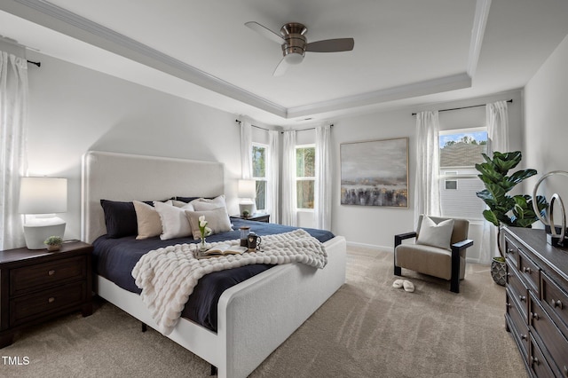 bedroom featuring crown molding, ceiling fan, a raised ceiling, and light colored carpet