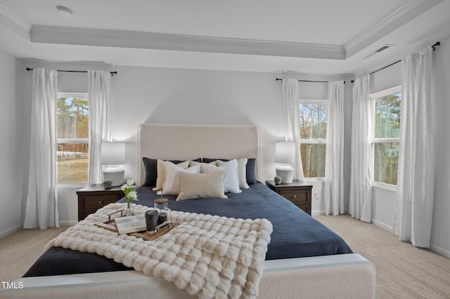 carpeted bedroom featuring a raised ceiling, multiple windows, and crown molding