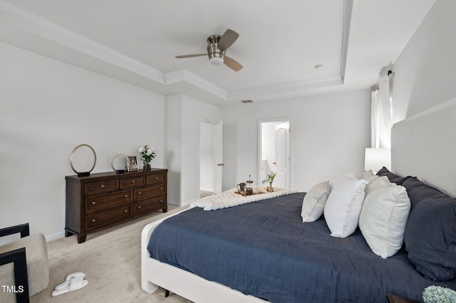 bedroom featuring ceiling fan, light colored carpet, visible vents, a raised ceiling, and crown molding