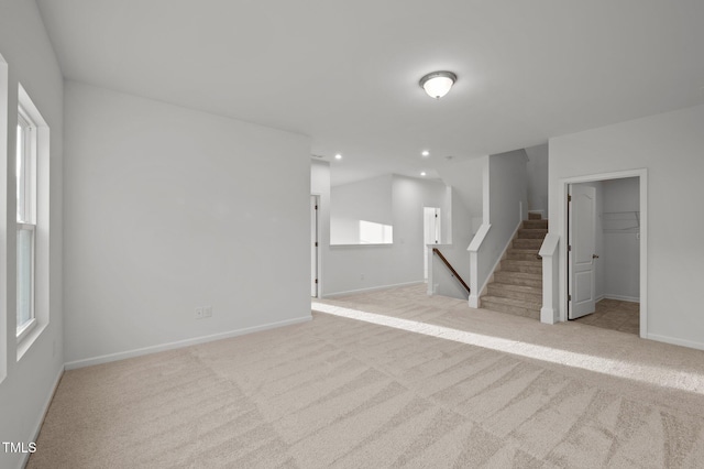 below grade area with carpet, stairway, baseboards, and recessed lighting