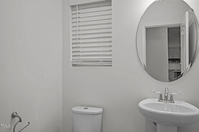 bathroom with toilet and a sink