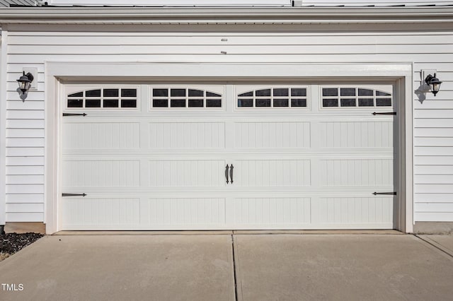 garage featuring concrete driveway