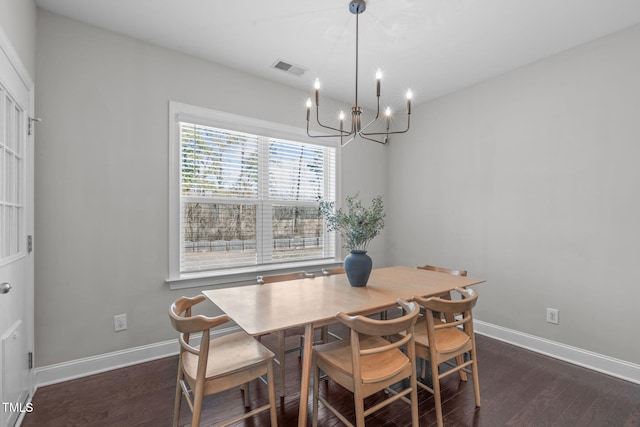 dining area with an inviting chandelier, visible vents, baseboards, and dark wood-type flooring