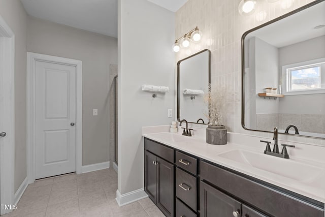 bathroom with double vanity, a stall shower, tile patterned flooring, and a sink