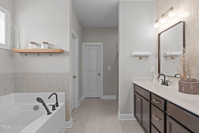 bathroom featuring double vanity, baseboards, a sink, tile patterned flooring, and a bath