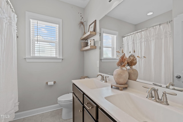 full bathroom with toilet, tile patterned flooring, baseboards, and a sink