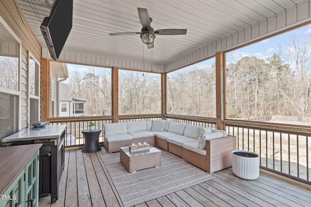 wooden terrace featuring ceiling fan and outdoor lounge area